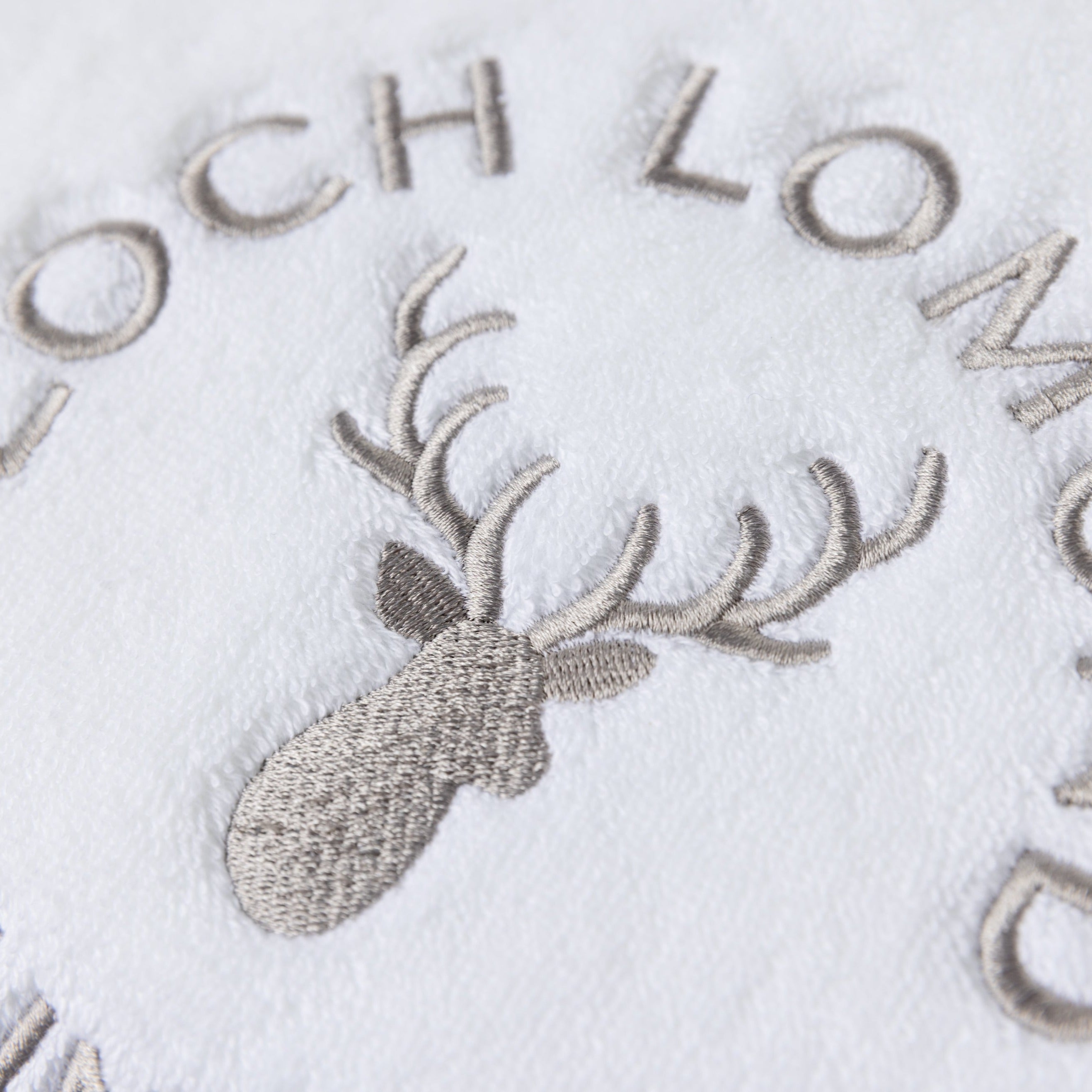 Macro photo of the Loch Lomond Linen logo embroidery