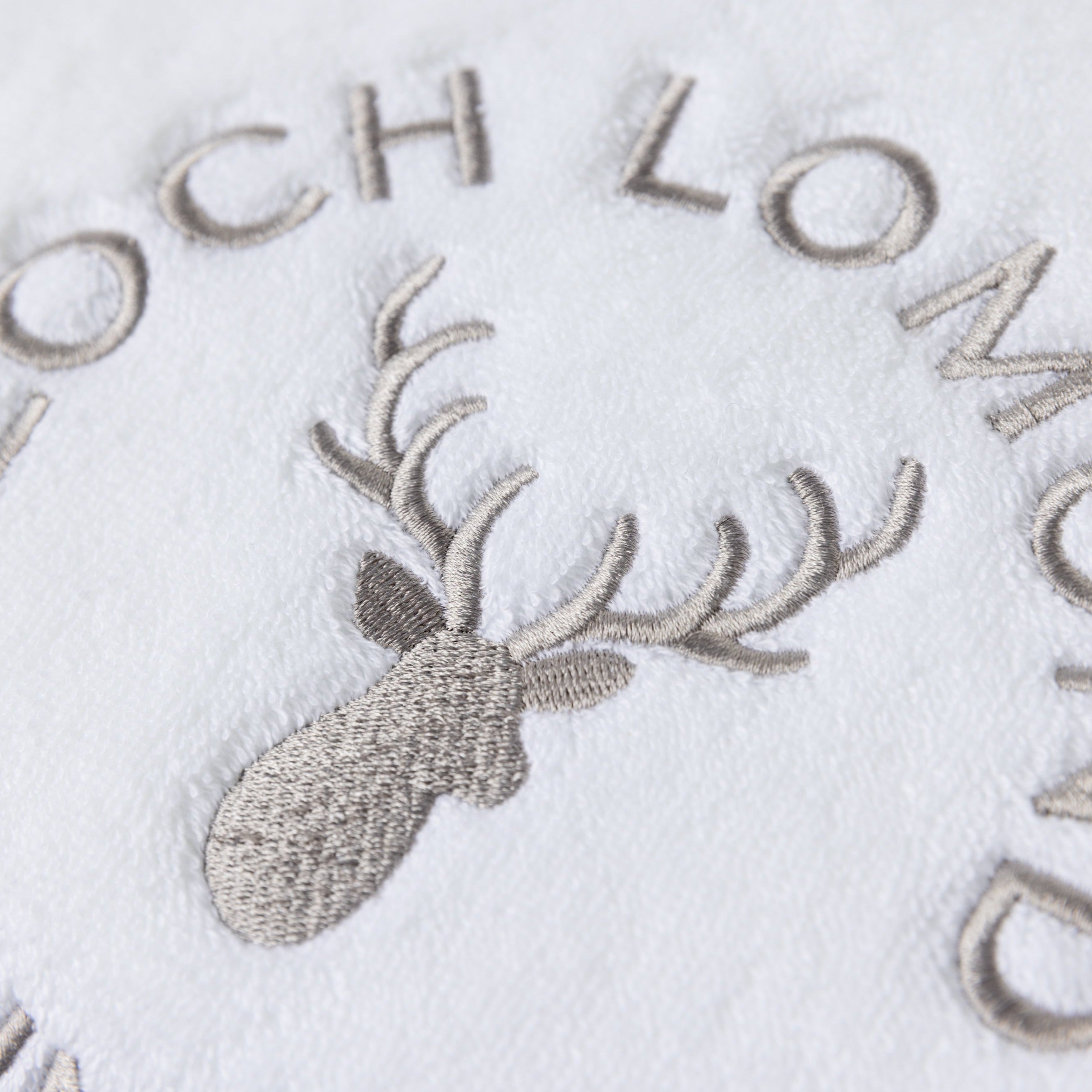 Macro photo of the Loch Lomond Linen logo embroidery