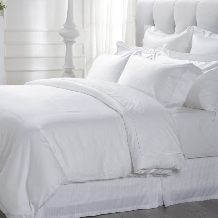 Loch Lomond Linen's luxury white pure cotton sateen duvet cover is shown on a bed