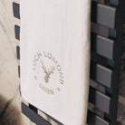Loch Lomond Linen's luxury bath towel is neatly folded and hung in an elegant bathroom.