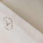 A sophisticated looking white cotton bath mat from Loch Lomond Linen is shown on the floor.