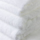 Close photo of the seven piece white 100% cotton bath towel set showing how exceptional and detailed the quality is.