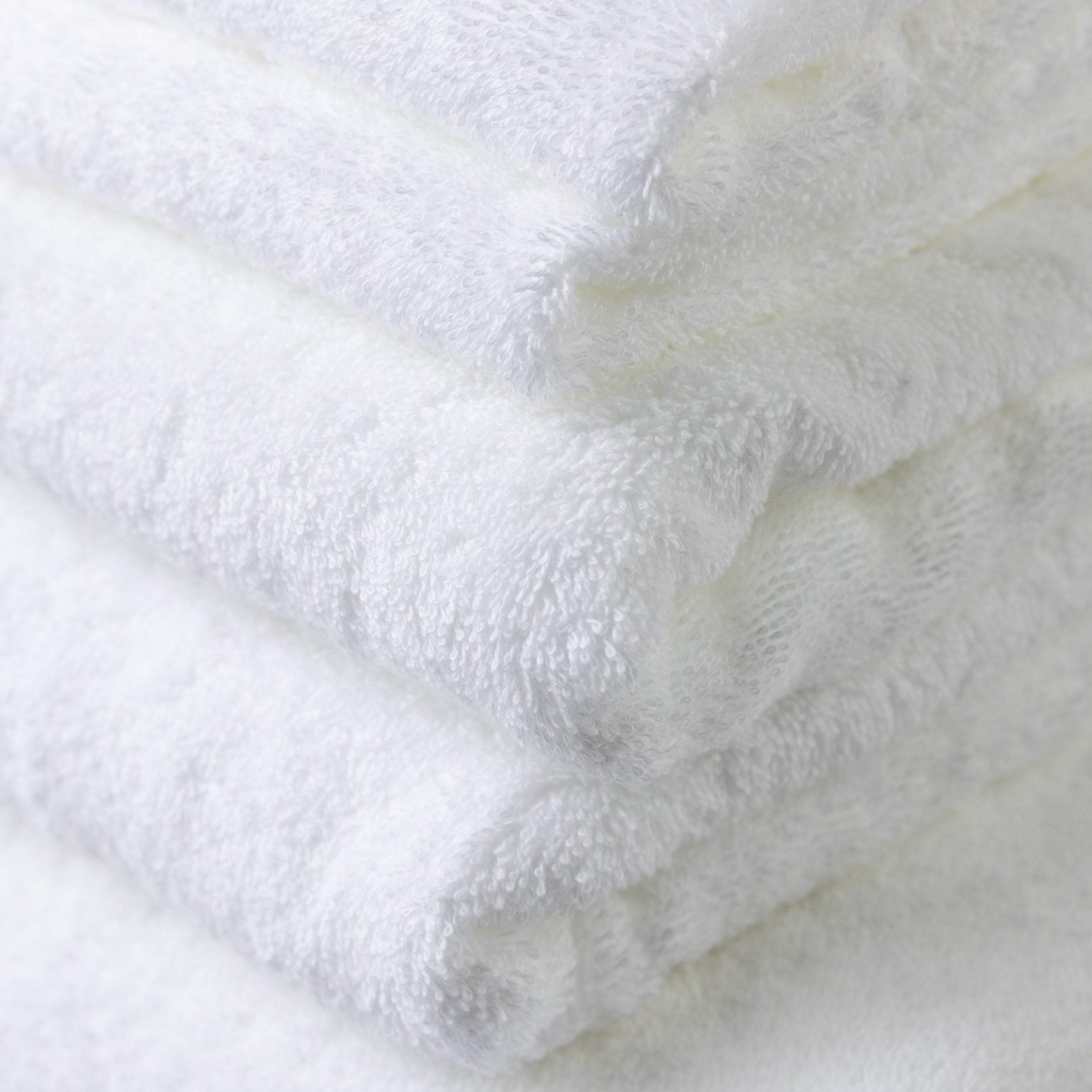 Close photo of the six piece white 100% cotton bath towel set showing how exceptional and detailed the quality is.