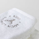A close photo of the white face towel with the Loch Lomond Linen logo.