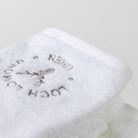 A close photo of the white face towel with the Loch Lomond Linen logo.
