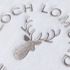 Macro photo of the Loch Lomond Linen logo embroidery