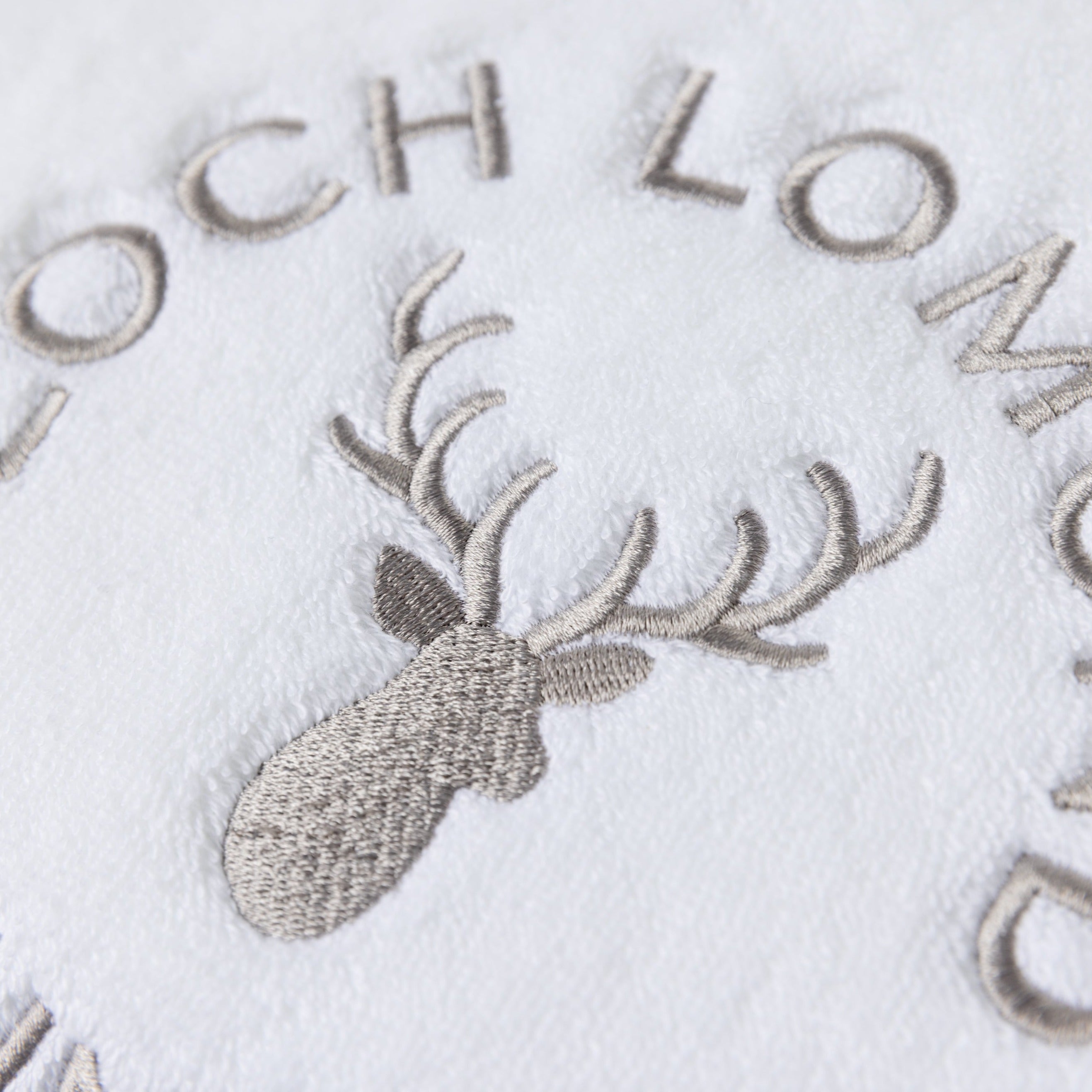 Macro photo of the Loch Lomond Linen logo embroidery