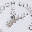Macro photo of the Loch Lomond Linen logo embroidery