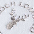 Macro photo of the Loch Lomond Linen logo embroidery