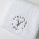 A close photo of the Loch Lomond Linen logo embroidered on the brand's luxurious, extra soft hand towel.