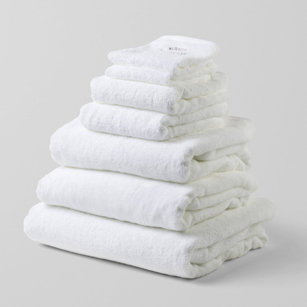 Loch Lomond Linen's seven piece bath sheet and towel set is shown neatly folded on top of each other. All the towels are white and made of the finest 100% cotton.