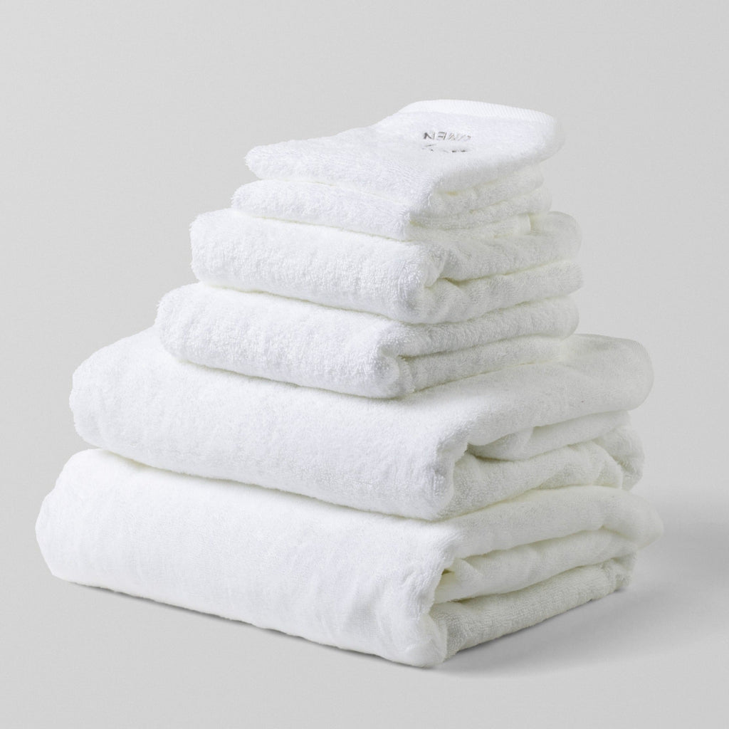 Loch Lomond Linen's six piece bath towel set is shown neatly folded on top of each other. All the towels are white and made of the finest 100% cotton.