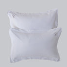 A pair of luxurious Oxford pillowcases are shown with Loch Lomond Linen's logo embroidered in the corners. Made of 100% cotton sateen to ensure the best night's sleep. Available in Standard and Super King sizes.