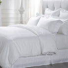 Loch Lomond Linen's luxury white pure cotton sateen duvet cover is shown on a bed 